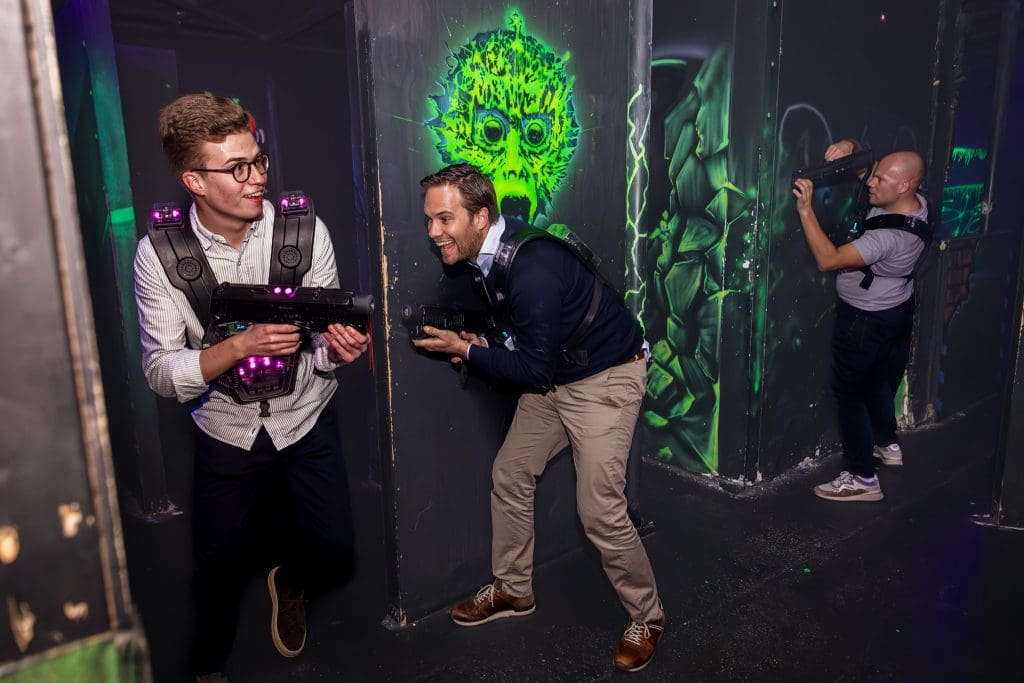 drie mannen die aan het lasergamen zijn